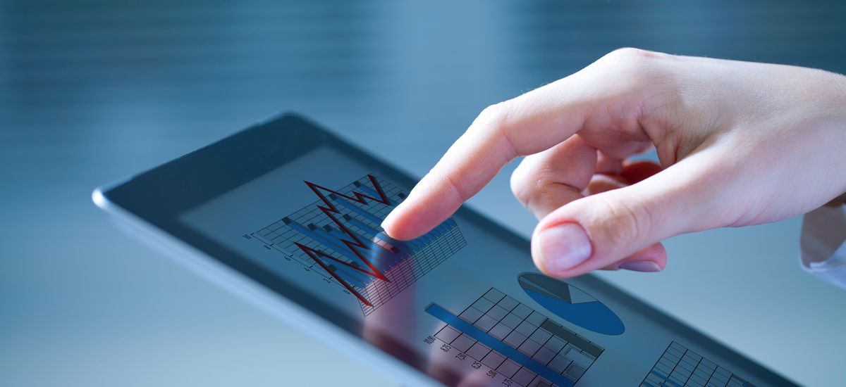 Close-up of female hands touching digital tablet with business diagram